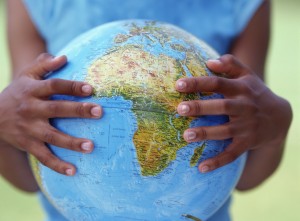 Girl's hands holding globe