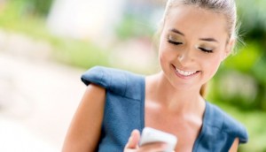 Portrait of a happy business woman texting on her phone